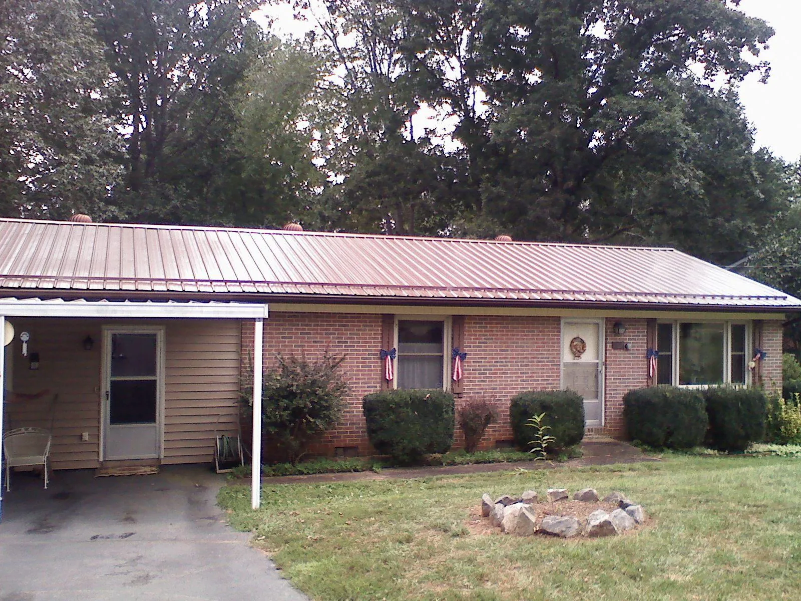 Bronze metal roof and carport on a brick ranch home — Roof Repair work by our crew in Saint Paul